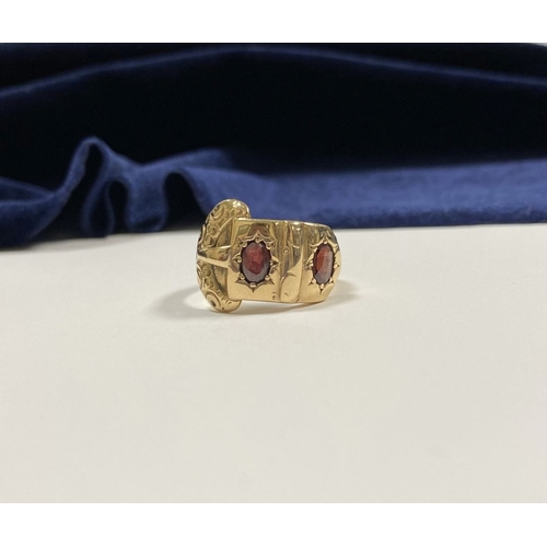 129 - A 14CT YELLOW GOLD GARNET BUCKLE RING, with featuring two illusion set oval cut garnets within highl... 