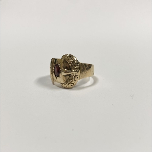 129 - A 14CT YELLOW GOLD GARNET BUCKLE RING, with featuring two illusion set oval cut garnets within highl... 