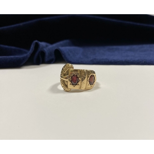 129 - A 14CT YELLOW GOLD GARNET BUCKLE RING, with featuring two illusion set oval cut garnets within highl... 