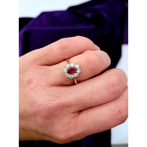 13 - A GORGEOUS 18CT YELLOW GOLD & PLATINUM DIAMOND & RUBY CLUSTER RING, an oval cut ruby is set to the c... 