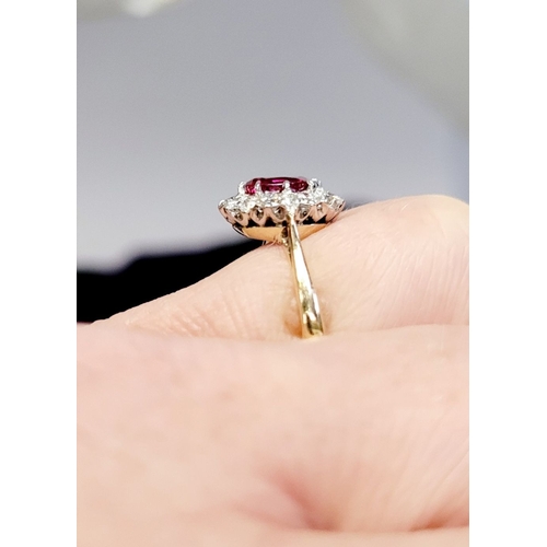 13 - A GORGEOUS 18CT YELLOW GOLD & PLATINUM DIAMOND & RUBY CLUSTER RING, an oval cut ruby is set to the c... 