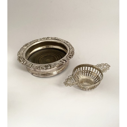 131 - AN EDWARD VII PIERCED SILVER TEA STRAINER ALONG WITH WINE COASTER, (i) the tea strainer of circular ... 