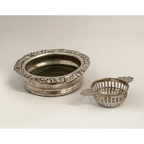 131 - AN EDWARD VII PIERCED SILVER TEA STRAINER ALONG WITH WINE COASTER, (i) the tea strainer of circular ... 