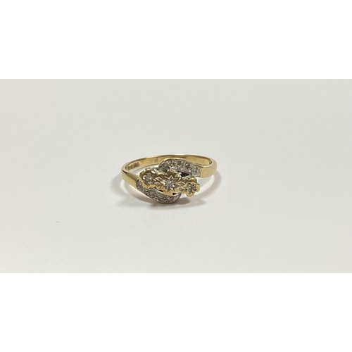 132 - A PRETTY 9CT YELLOW GOLD DIAMOND RING, with three round cut diamonds in illusion setting to centre, ... 