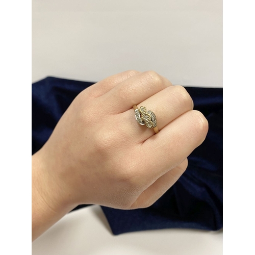 132 - A PRETTY 9CT YELLOW GOLD DIAMOND RING, with three round cut diamonds in illusion setting to centre, ... 