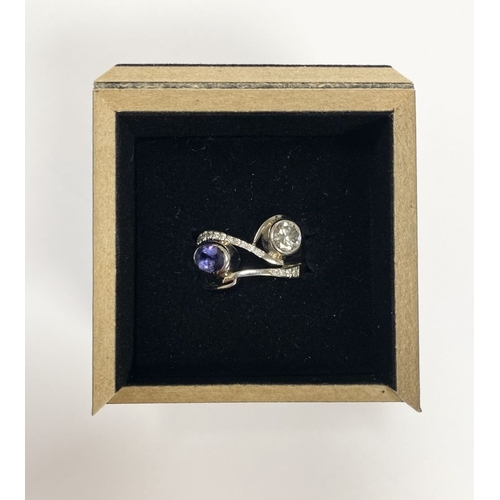 14 - A STUNNING HANDMADE PLATINUM DIAMOND AND TANZANITE RING, with beautiful round brilliant cut diamond ... 