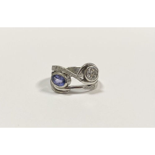 14 - A STUNNING HANDMADE PLATINUM DIAMOND AND TANZANITE RING, with beautiful round brilliant cut diamond ... 