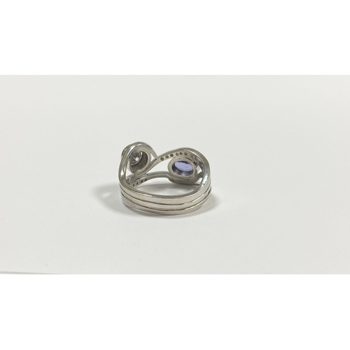 14 - A STUNNING HANDMADE PLATINUM DIAMOND AND TANZANITE RING, with beautiful round brilliant cut diamond ... 