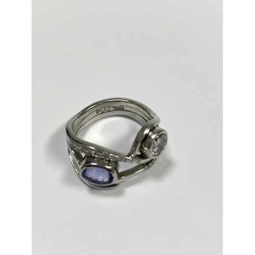 14 - A STUNNING HANDMADE PLATINUM DIAMOND AND TANZANITE RING, with beautiful round brilliant cut diamond ... 