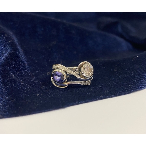 14 - A STUNNING HANDMADE PLATINUM DIAMOND AND TANZANITE RING, with beautiful round brilliant cut diamond ... 