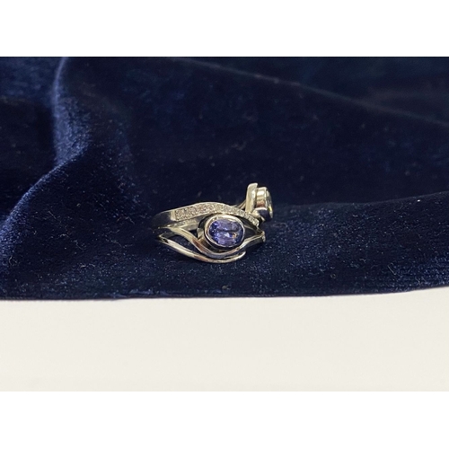 14 - A STUNNING HANDMADE PLATINUM DIAMOND AND TANZANITE RING, with beautiful round brilliant cut diamond ... 