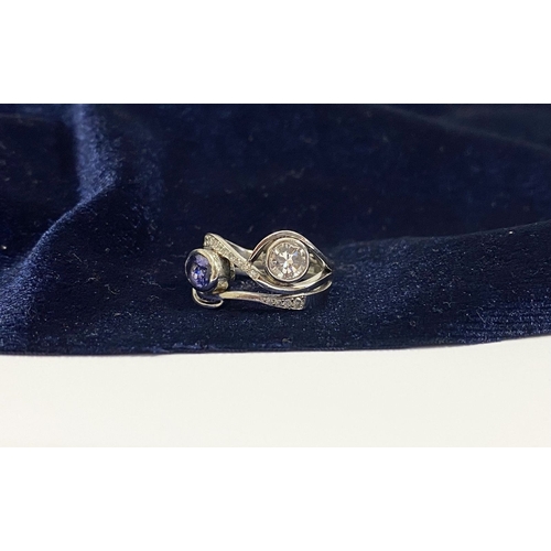 14 - A STUNNING HANDMADE PLATINUM DIAMOND AND TANZANITE RING, with beautiful round brilliant cut diamond ... 