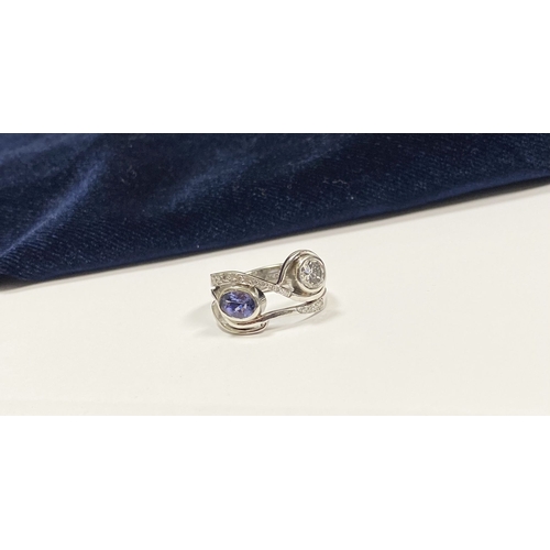 14 - A STUNNING HANDMADE PLATINUM DIAMOND AND TANZANITE RING, with beautiful round brilliant cut diamond ... 