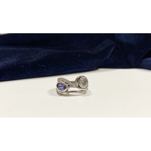 14 - A STUNNING HANDMADE PLATINUM DIAMOND AND TANZANITE RING, with beautiful round brilliant cut diamond ... 