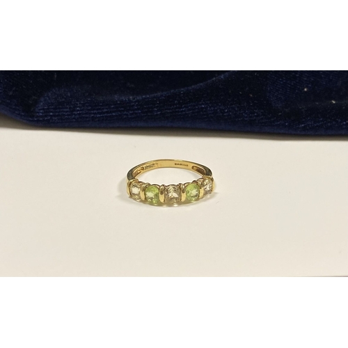 148 - A PRETTY 9CT YELLOW GOLD FIVE STONE RING, with five round cut gemstones alternating in colour in rai... 