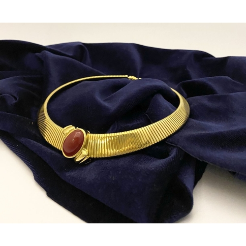 149 - A VINTAGE MONET GOLD TONE OMEGA COLLAR NECKLACE, c.1980, the gold-tone collar featuring an oval-shap... 