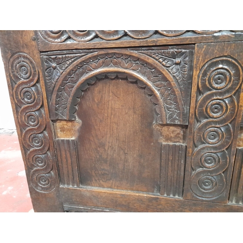 154 - AN LARGE ANTIQUE TRUNK, with nicely carved triple panel design to front, metal fittings, opening to ... 