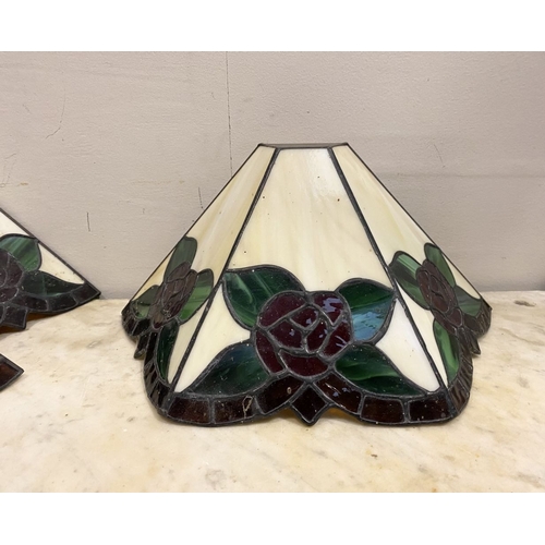 167 - A SET OF FOUR TIFFANY STYLE GLASS WALL SCONCE LAMPSHADES, each features three glass panels with rose... 