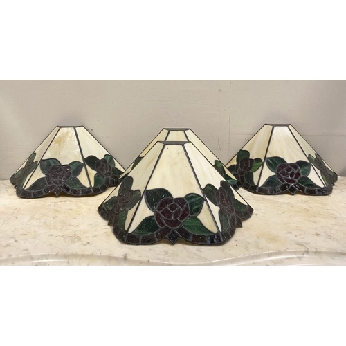 167 - A SET OF FOUR TIFFANY STYLE GLASS WALL SCONCE LAMPSHADES, each features three glass panels with rose... 