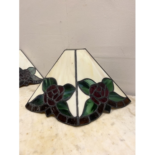 167 - A SET OF FOUR TIFFANY STYLE GLASS WALL SCONCE LAMPSHADES, each features three glass panels with rose... 