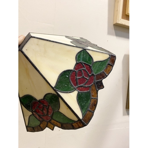 167 - A SET OF FOUR TIFFANY STYLE GLASS WALL SCONCE LAMPSHADES, each features three glass panels with rose... 