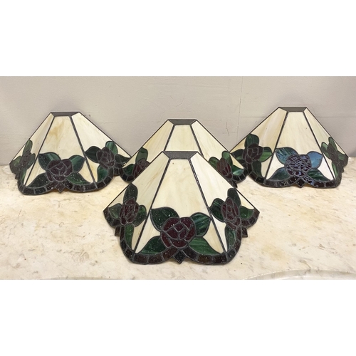 167 - A SET OF FOUR TIFFANY STYLE GLASS WALL SCONCE LAMPSHADES, each features three glass panels with rose... 