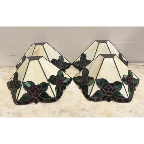 167 - A SET OF FOUR TIFFANY STYLE GLASS WALL SCONCE LAMPSHADES, each features three glass panels with rose... 