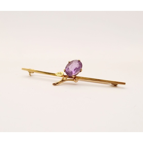 18 - A CASED 9CT YELLOW GOLD AND AMETHYST BROOCH, with a large oval cut amethyst stone in a claw setting ... 