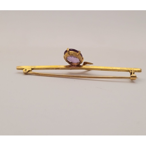 18 - A CASED 9CT YELLOW GOLD AND AMETHYST BROOCH, with a large oval cut amethyst stone in a claw setting ... 