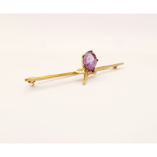 18 - A CASED 9CT YELLOW GOLD AND AMETHYST BROOCH, with a large oval cut amethyst stone in a claw setting ... 