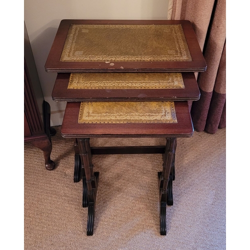 209 - A VERY GOOD NEST OF THREE LEATHER TOPPED SIDE TABLES, each with a lovely panel of gilt tooled green ... 