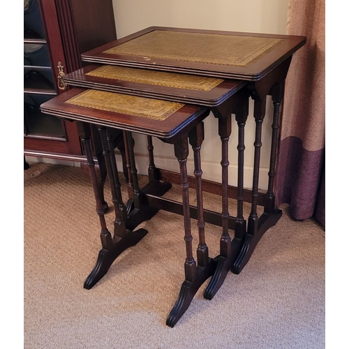 209 - A VERY GOOD NEST OF THREE LEATHER TOPPED SIDE TABLES, each with a lovely panel of gilt tooled green ... 