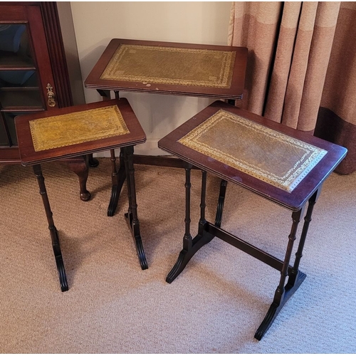 209 - A VERY GOOD NEST OF THREE LEATHER TOPPED SIDE TABLES, each with a lovely panel of gilt tooled green ... 