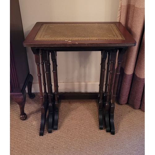 209 - A VERY GOOD NEST OF THREE LEATHER TOPPED SIDE TABLES, each with a lovely panel of gilt tooled green ... 