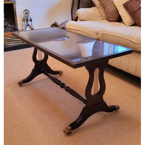 210 - A GOOD MAHOGANY GLASS TOPPED COFFEE TABLE WITH LYRE SUPPORTS, the rectangular table has a reed edge ... 