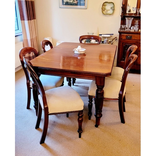 215 - A GOOD QUALITY 20TH CENTURY MAHOGANY DINING TABLE, with canted corners and raised on beautiful turne... 