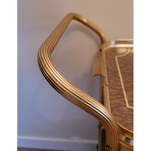 219 - A GILT METAL & FAUX WALNUT TWO TIER MID-CENTURY TROLLEY BAR CART, with lovely reed detail to the cur... 