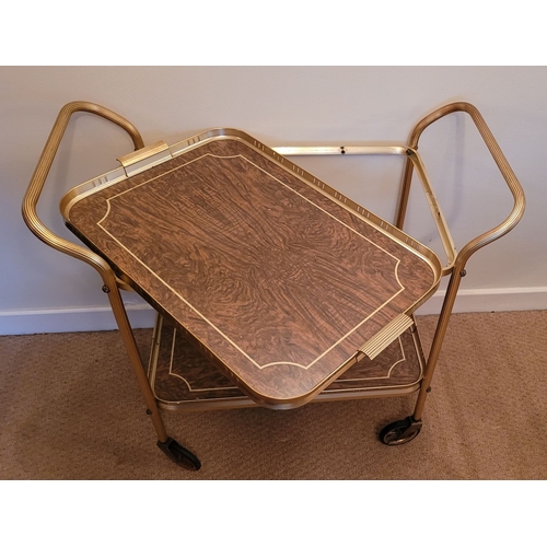 219 - A GILT METAL & FAUX WALNUT TWO TIER MID-CENTURY TROLLEY BAR CART, with lovely reed detail to the cur... 