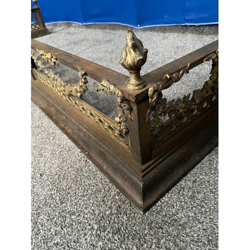 239 - A GOOD QUALITY STEEL & BRASS FENDER, with four finials to top rail, central panel with torch surroun... 