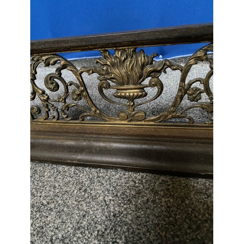 239 - A GOOD QUALITY STEEL & BRASS FENDER, with four finials to top rail, central panel with torch surroun... 