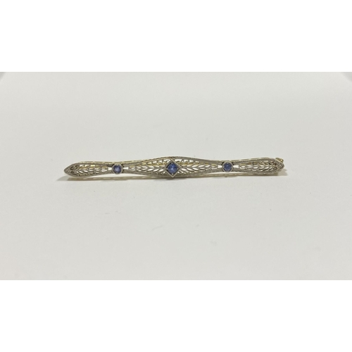 24 - A BEAUTIFUL ART DECO 14CT GOLD SAPPHIRE BAR BROOCH, set with three vibrant round cut sapphires, the ... 