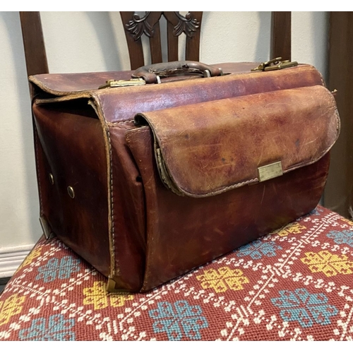 242 - A VINTAGE LEATHER GERMAN SUDHAUS TRAVEL BAG, with fold over top, double clasp opening, with pouch to... 