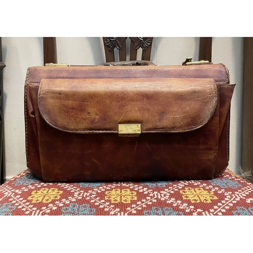 242 - A VINTAGE LEATHER GERMAN SUDHAUS TRAVEL BAG, with fold over top, double clasp opening, with pouch to... 