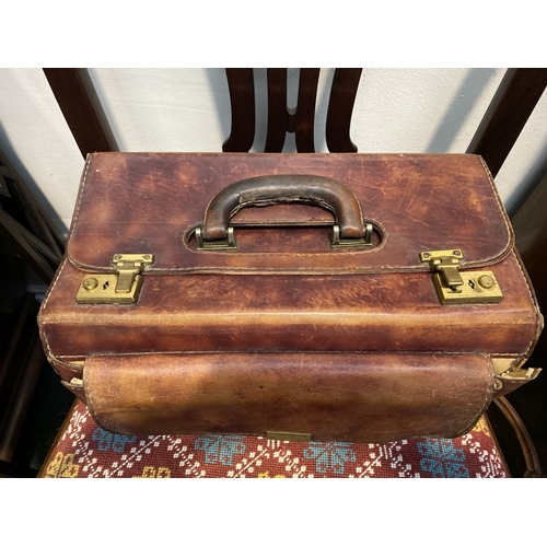 242 - A VINTAGE LEATHER GERMAN SUDHAUS TRAVEL BAG, with fold over top, double clasp opening, with pouch to... 