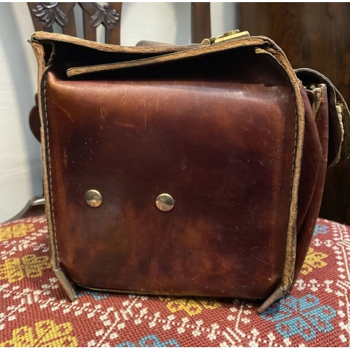 242 - A VINTAGE LEATHER GERMAN SUDHAUS TRAVEL BAG, with fold over top, double clasp opening, with pouch to... 