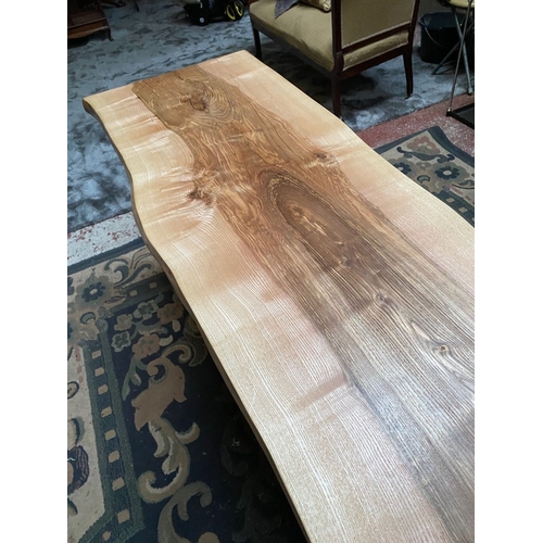 258 - A LONG RECLAIMED WOOD COFFEE TABLE, could be walnut/elm, on steel side supports. Dimensions: 214cm l... 