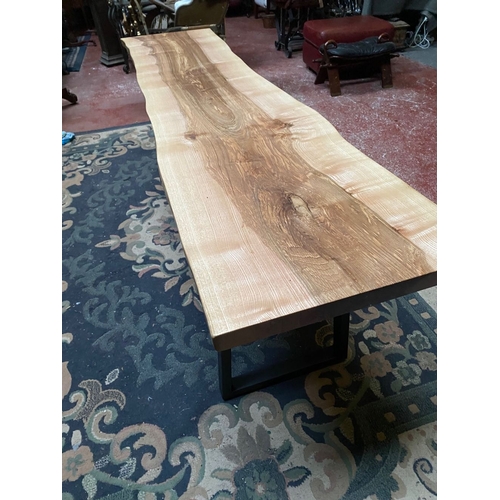 258 - A LONG RECLAIMED WOOD COFFEE TABLE, could be walnut/elm, on steel side supports. Dimensions: 214cm l... 