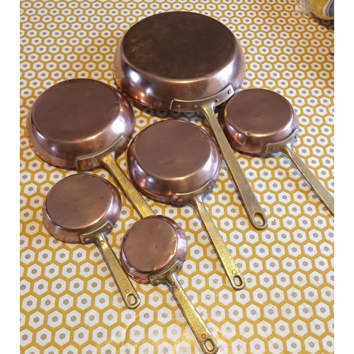 265 - A SET OF SIX VINTAGE GRADUATED COPPER PANS, with tinned interiors, largest diameter 23cm, overall le... 