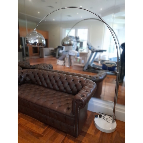 284 - A LARGE STAINLESS STEEL FLOOR LAMP, with curved support, on circular granite base. Dimensions: 198cm... 