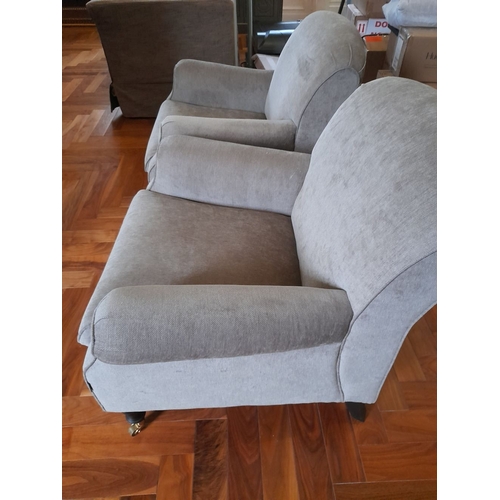 286 - A PAIR OF GREY UPHOLSTERED ARMCHAIRS, on turned leg with castors. Dimensions: 84cm wide x 82cm high ... 